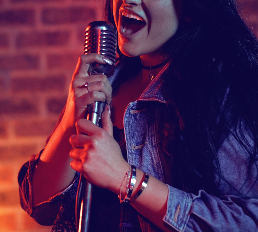 female singer with long hair singing