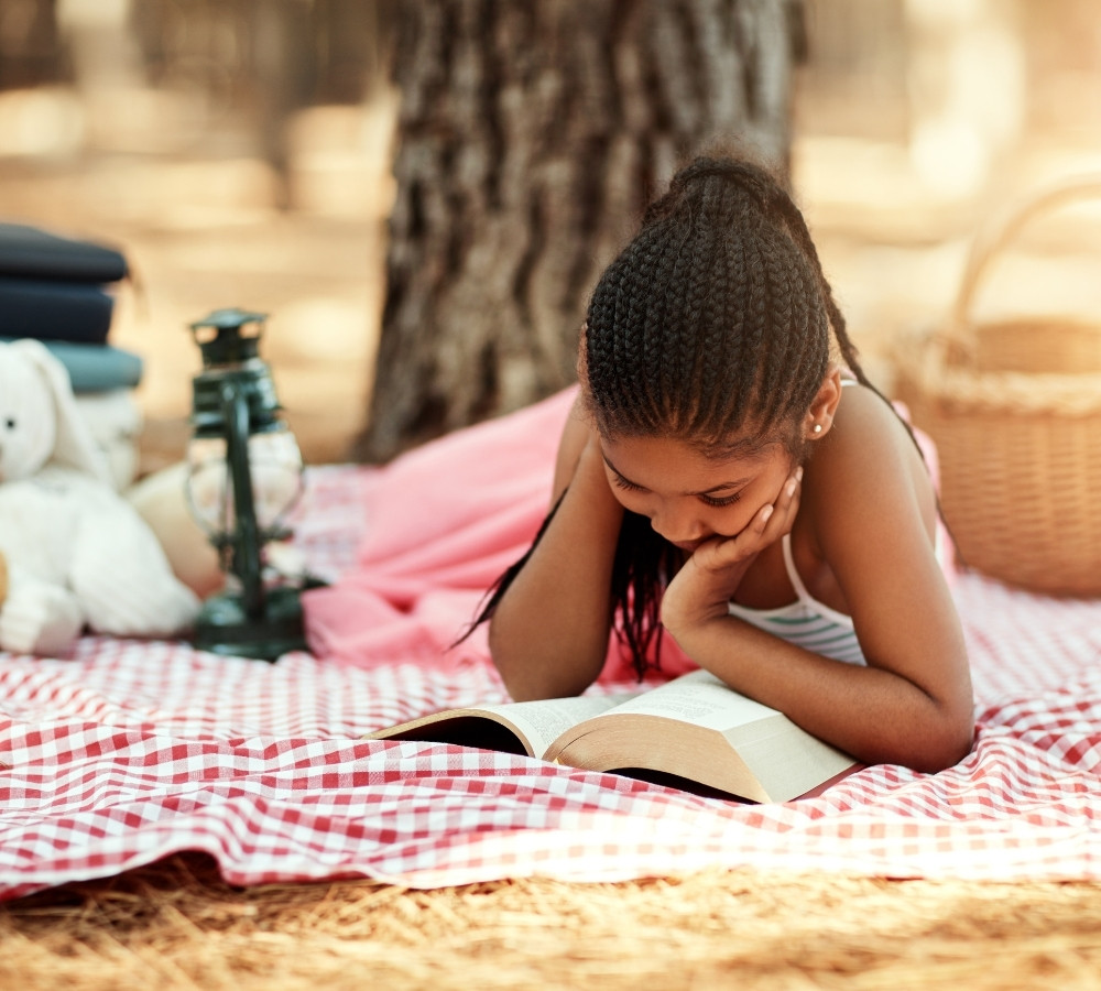 little girl reading a book