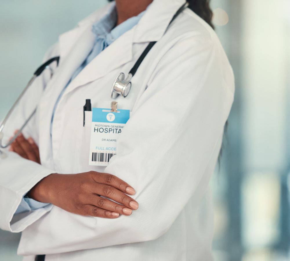 Confident doctor arms crossed in the hospital