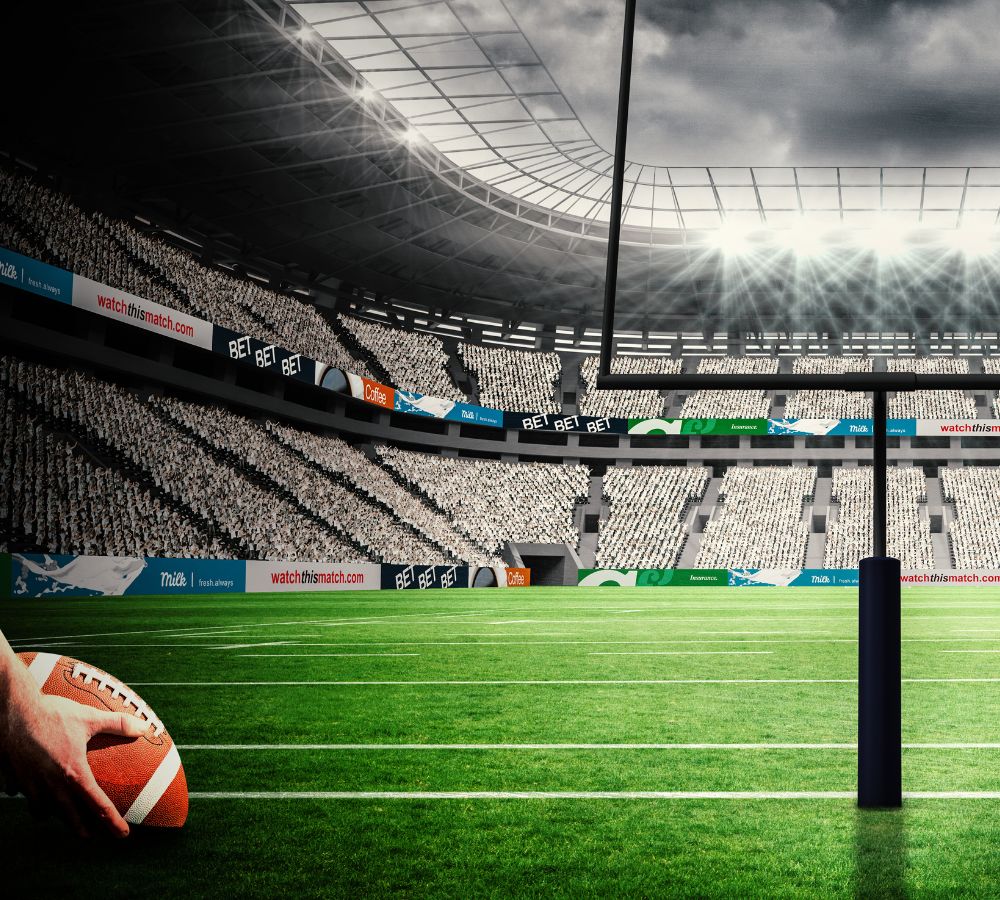 football player preparing for a drop kick against american football arena