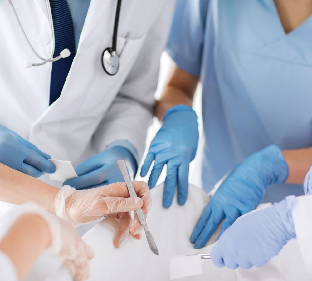 young group of doctors doing operation