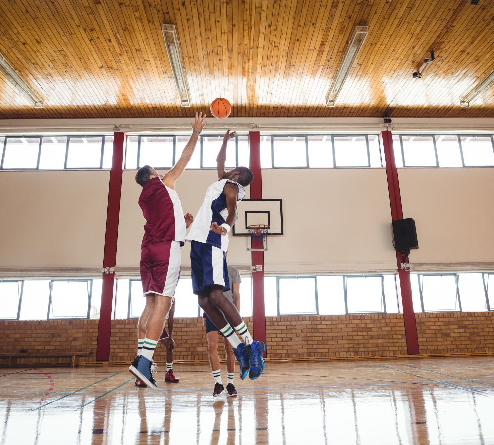 Basketball players playing basketball in the court