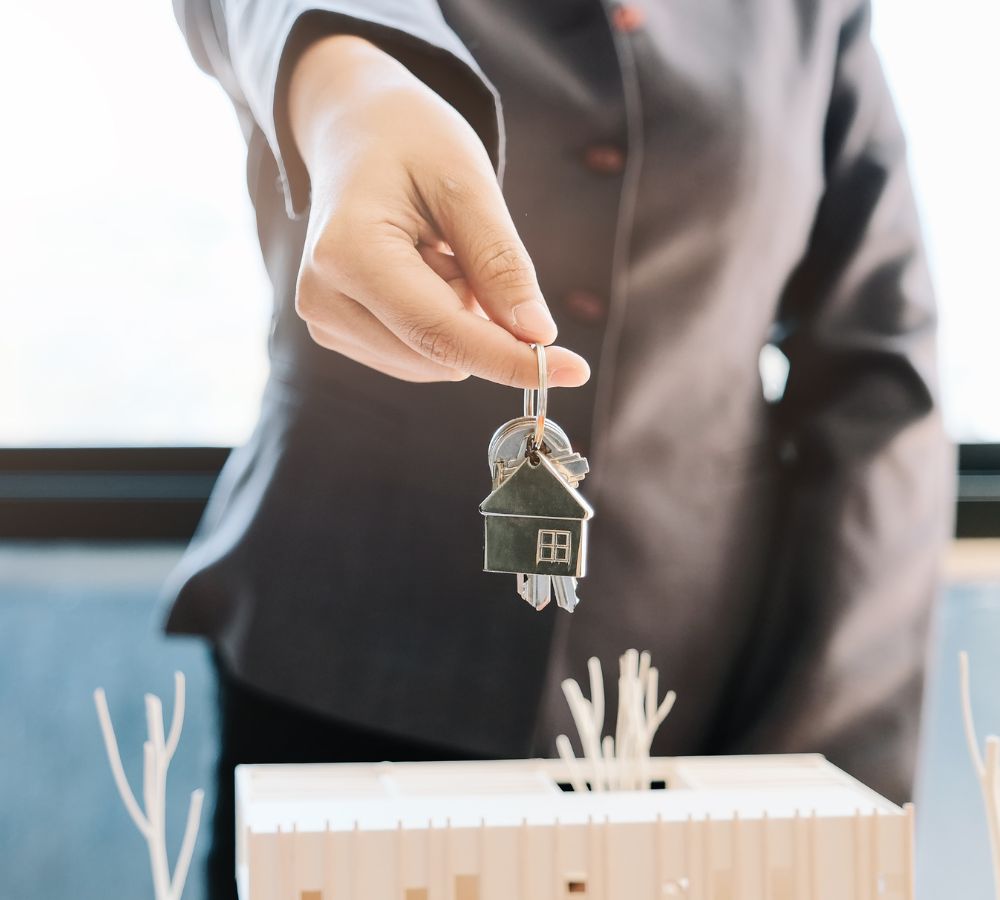 Real estate agent handing the house key
